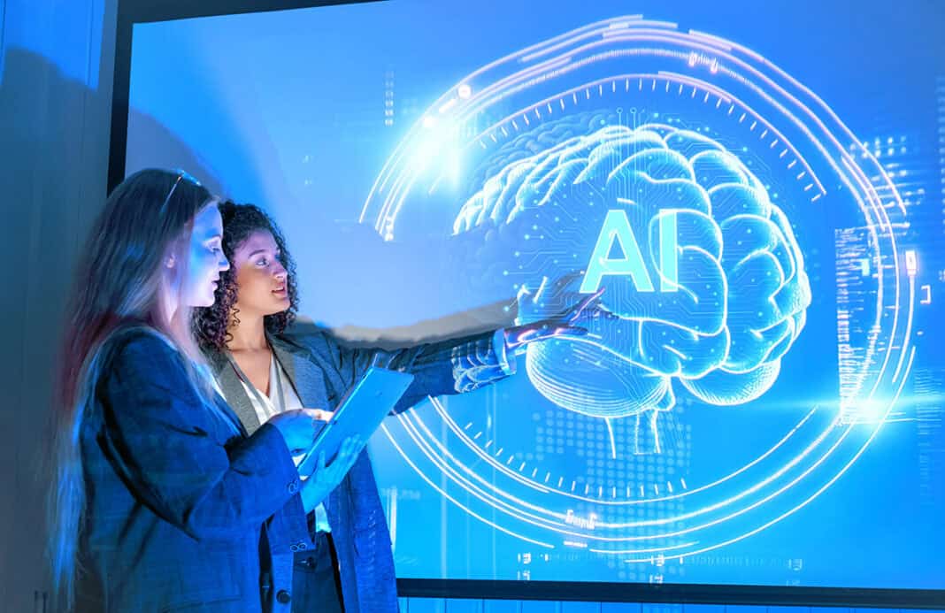 Two presenters discussing artificial intelligence and technology visualized on a screen Schule ohne Unterricht, aber dafür mit KI!?